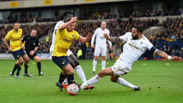 Kyle Bartley of Swansea City brings down Alex MacDonald