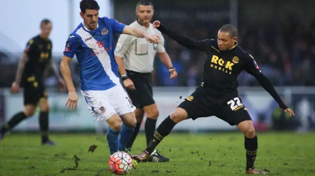 Eastleigh captain Ben Strevens and Bolton's Wellington Silva