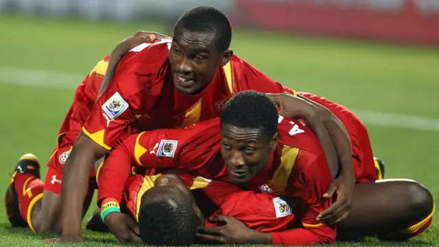 Asamoah Gyan (R) of Ghana celebrates victory with