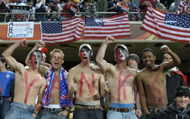 US supporters with painted chests stand to spell out 'Yanks' as others wave US flags before the 2010 World Cup round of 16 football match USA vs. Ghana