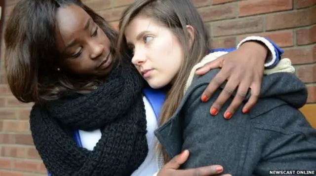 Woman comforting young girl