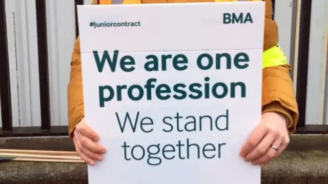 Junior doctor holding a placard