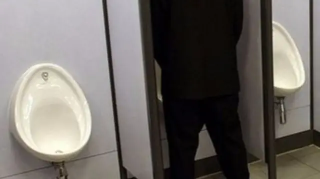 Man using a urinal