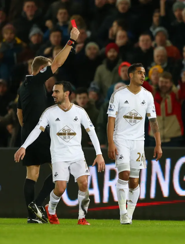 Swansea's Kyle Naughton is shown a red card