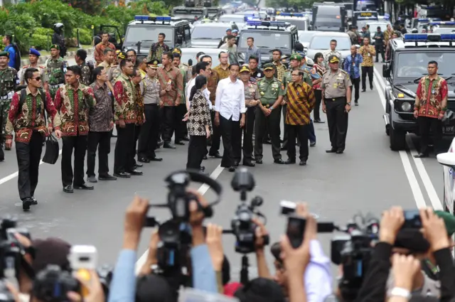 Indonesian president Joko Widodo (centre, white shirt) visits the site of a bomb blast