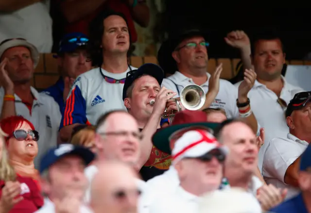 An England fan plays a trumpet