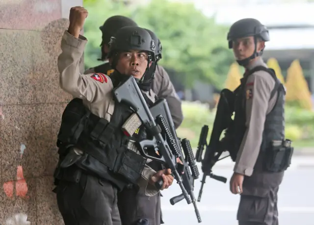 Armed police search a building in Jakarta on 14 January 2016