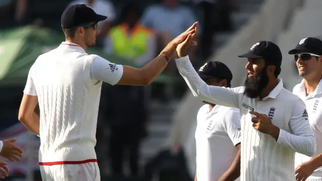 Steven Finn and Moeen Ali celebrate