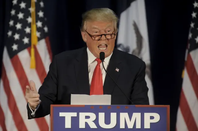 U.S. Republican presidential candidate Donald Trump reads the lyrics of Al Wilson"s "The Snake" at a campaign event at University of Northern Iowa