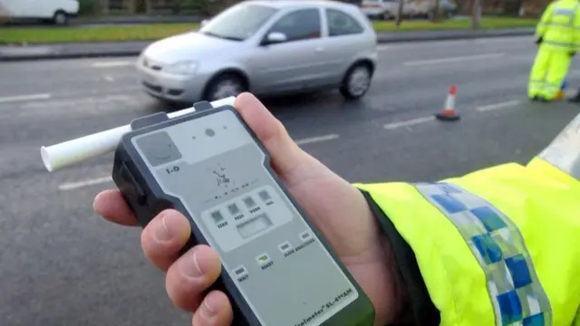 Police officer holds a breathalyser