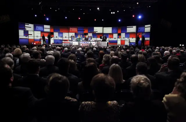 Former Arkansas Governor Mike Huckabee (on stage, L to R), former HP CEO Carly Fiorina and former U.S. Senator Rick Santorum participate in a forum for lower polling candidates at the Fox Business Network Republican presidential candidates debate