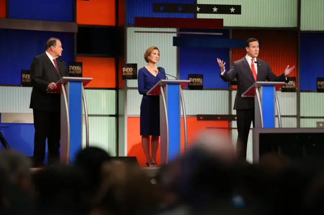 Republican presidential candidates (L-R) Mike Huckabee, Carly Fiorina and Rick Santorum participate in the Fox Business Network Republican presidential debate at the North Charleston Coliseum and Performing Arts Center on January 14, 2016 in North Charleston, South Carolina. The sixth Republican debate is held in two parts, one main debate for the top seven candidates, and another for three other candidates lower in the current polls.