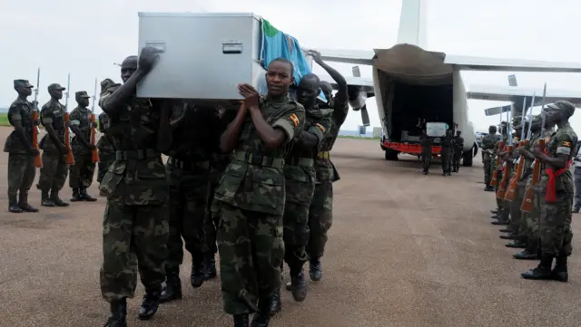 Ugandan soldiers bringing coffins home