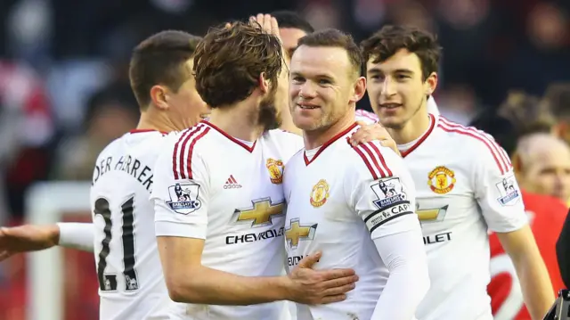 Wayne Rooney celebrates with United team-mates