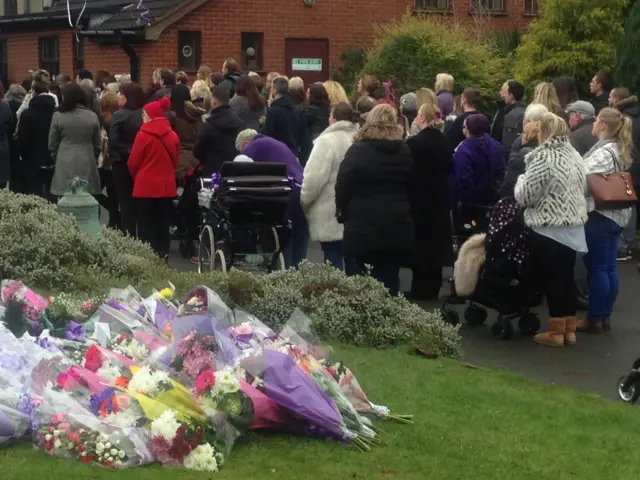 People listening to the service outside the church