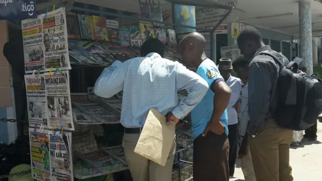 Tanzanians at a news stand