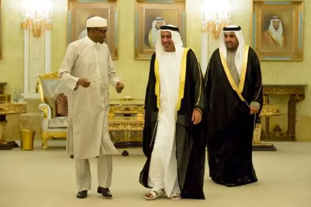 L: Muhhamudu Buhari C: Sheikh Mohammed Bin Zayed Al Nahyan R: UAE official