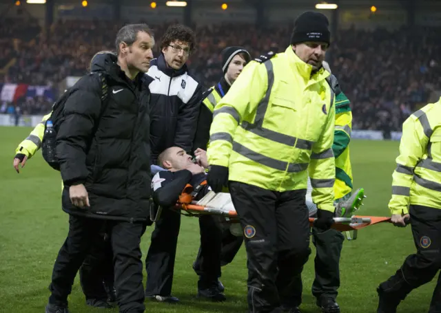 Dundee defender James McPake is stretchered off against Dundee United