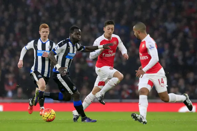 Mesut Ozil and Newcastle United's Cheick Tiote in action