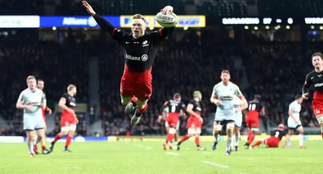 Saracens' Chris Aston leaps to score a try against Worcester