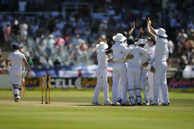 James Taylor walks off as the South Africa players celebrate