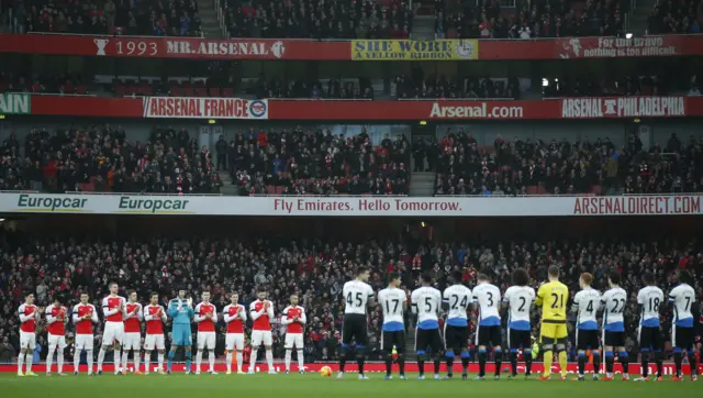 Arsenal and Newcastle players applaud ahead of the game