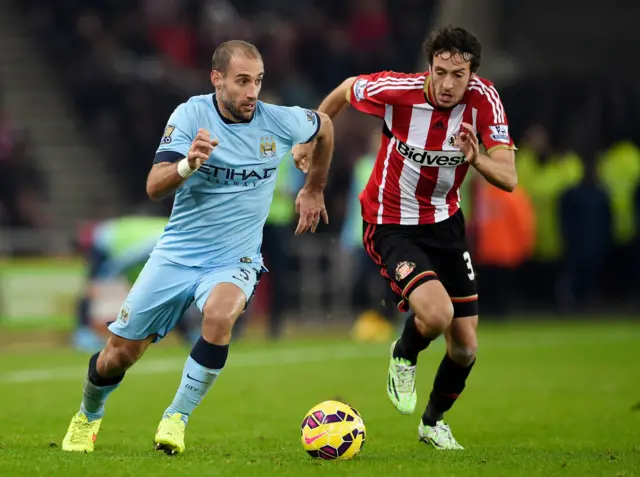 Pablo Zabaleta of Manchester City is pursued by Will Buckley of Sunderland during the Barclays Premier League match between Sunderland and Manchester City at The Stadium of Light on December 3, 2014