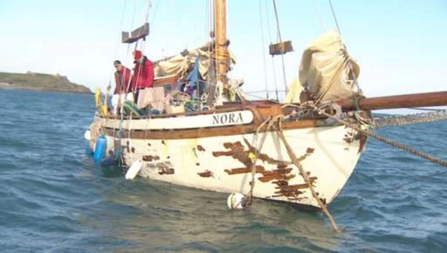 The men on board their boat Nora