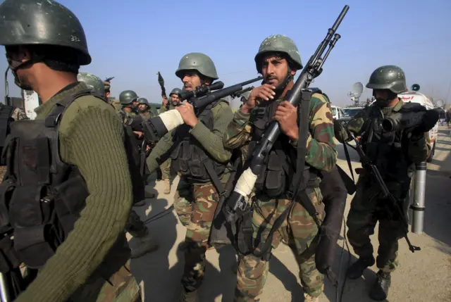 Army soldiers walk outside the Bacha Khan university in Charsadda