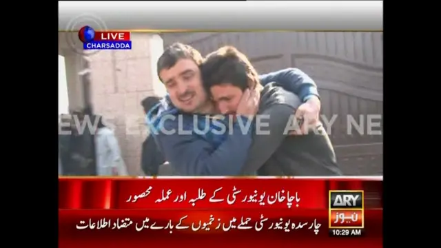 Two men console each other as people are evacuated at the Bacha Khan University during an attack by militants, in Charsadda, northwestern Pakistan in this still frame taken from a video released by ARY News 20 January 2016