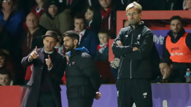 Liverpool manager Jurgen Klopp (right) and Exeter boss Paul Tisdale