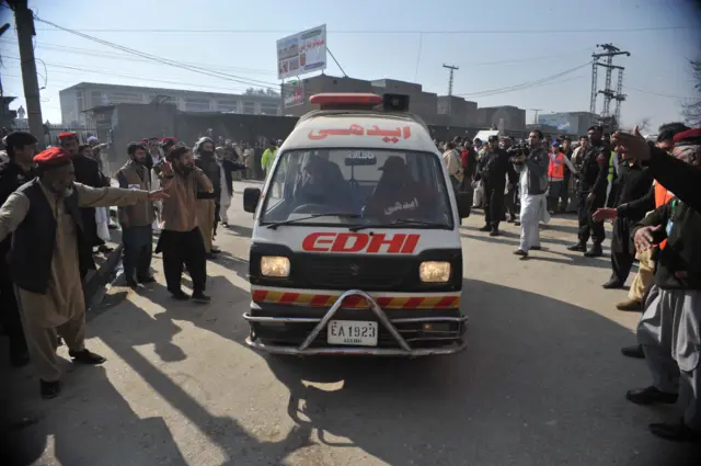 An ambulance carrying injured victims enters a hospital following an attack by gunmen at Bacha Khan university in Charsadda