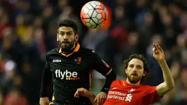 Liverpool's Joe Allen in action with Exeter's Danny Butterfield