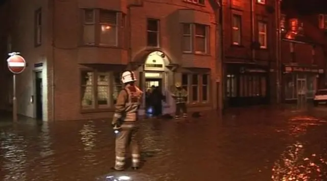 Firemen dealing with floods