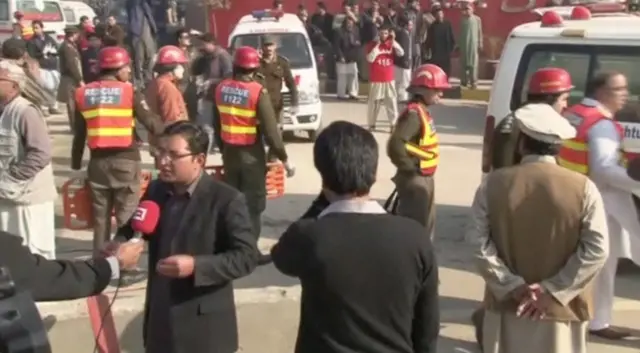 Rescue workers are seen outside Bacha Khan University where an attack by militants took place, in Charsadda