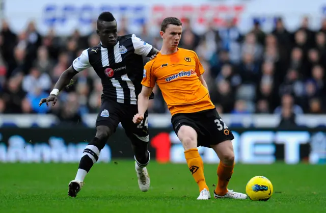 Newcastle player Cheick Tiote (L) challenges Wolves player Kevin Foley