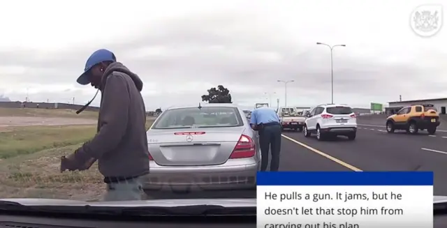 South African police officer near a car