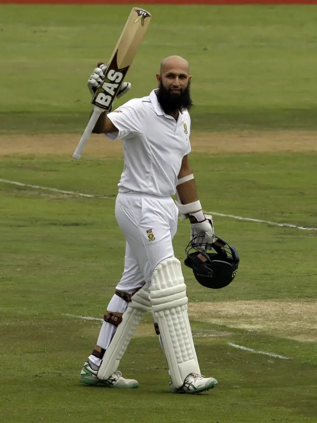 Hashim Amla raises hit bat after reaching his 100