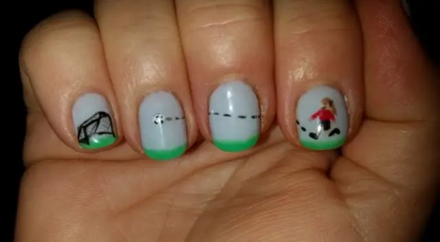 Fingernails painted with football scene