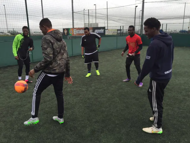 group of guys practicing their football techniques