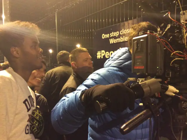 back of BBC camera operator filming a 5-a-side game