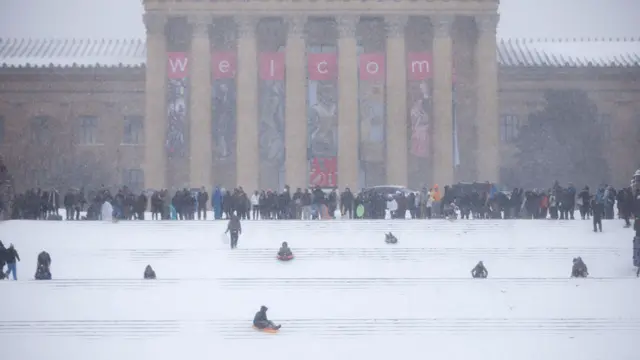 Philadelphia Art Museum steps are crowded with sledgers as snow continues to fall