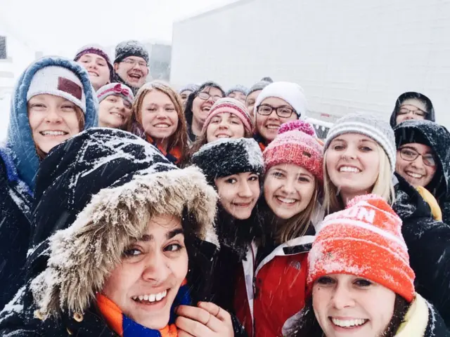 Students at University of Mary in North Dakota huddled together for a snow selfie