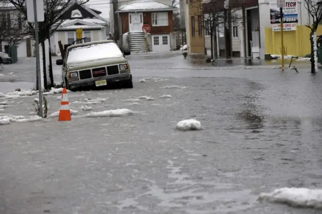 Water runs through a neighborhood on Winchester Avenue during a storm Saturday, Jan. 23, 2016, in Atlantic City, N.J