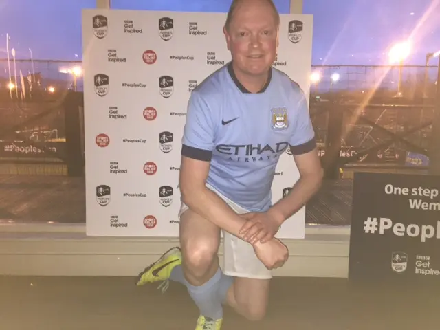 Paul Baker posing for photo with FA People's Cup branding in the background