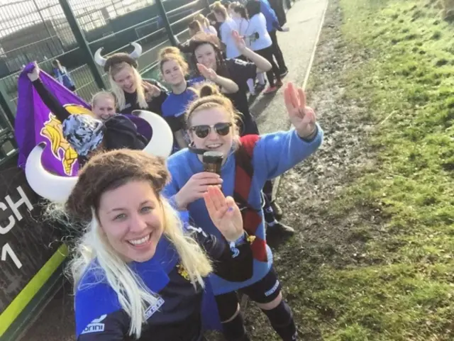 Row of female footballers in viking wigs