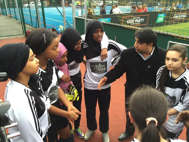 Unity of Faiths FC huddle after their 2-1 win over Arsenal Girls