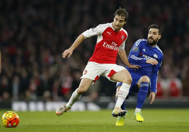 Cesc Fabregas in action with Arsenal's Mathieu Flamini