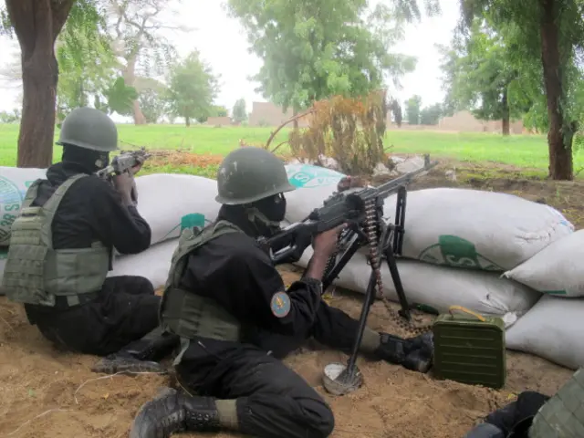 This photo taken on June 17, 2014 in the border town of Amchide, northern Cameroon, shows police forces of the multi-purpose intervention brigade holding a surveillance position, as part of a reinforcement of its military action against Nigerian Islamist group Boko Haram.