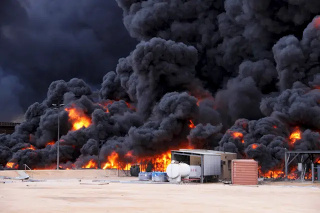 Smoke rises from burning oil storage tanks in the port of Ras Lanuf, Libya, January 23, 2016